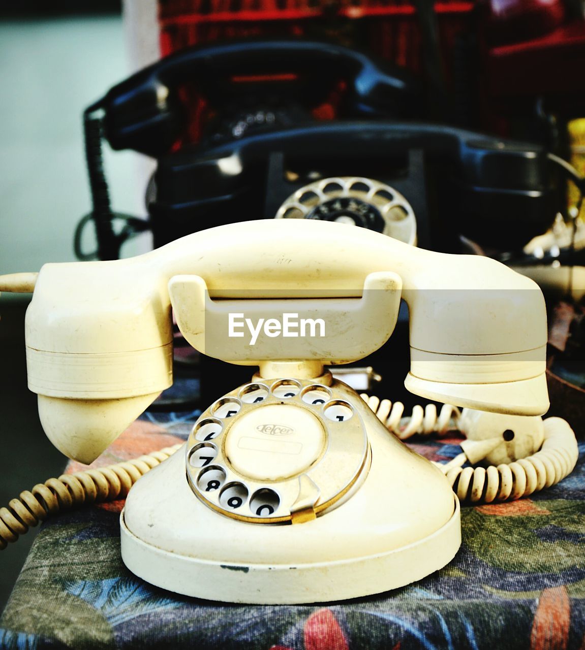 CLOSE-UP OF OLD TELEPHONE BOOTH AND TABLE