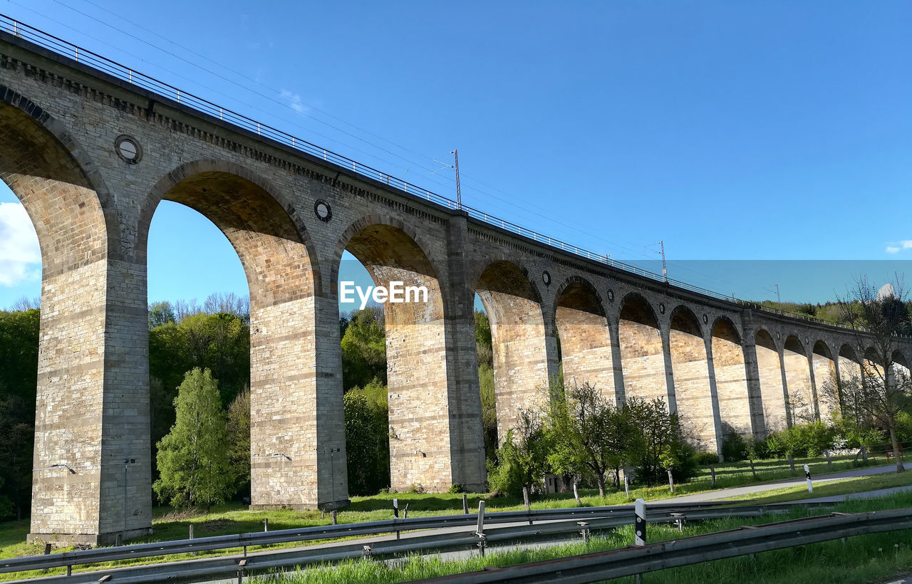 Low angle view of arch bridge against clear sky