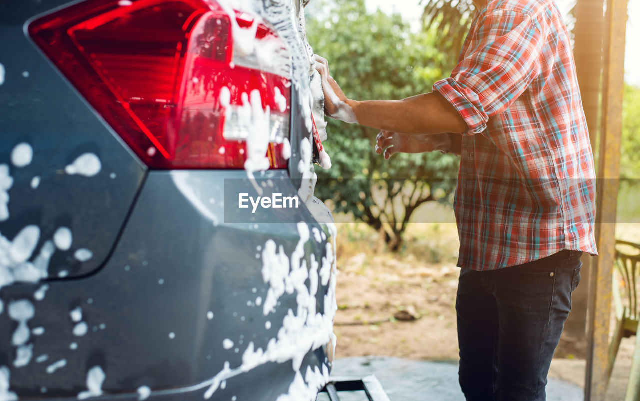 Men are washing cars with foam
