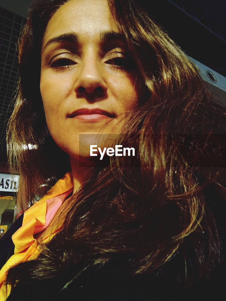 Low angle portrait of woman outdoors at night