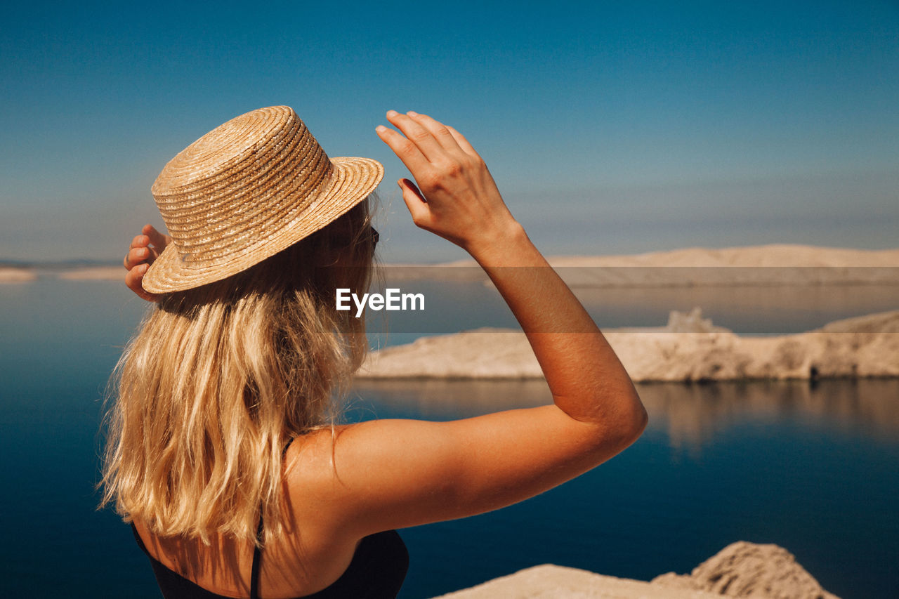 Woman wearing hat against sky