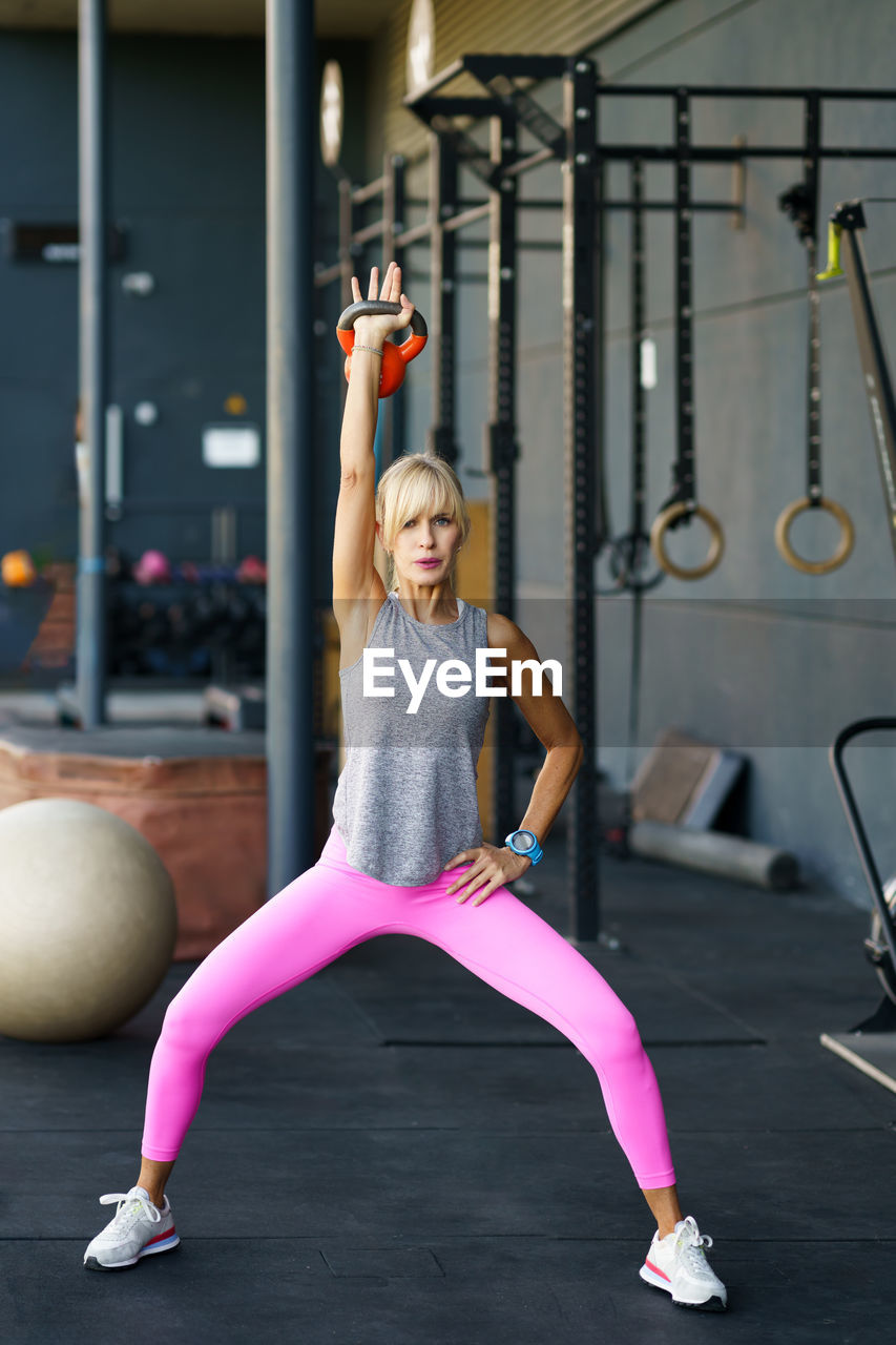 rear view of woman exercising in gym