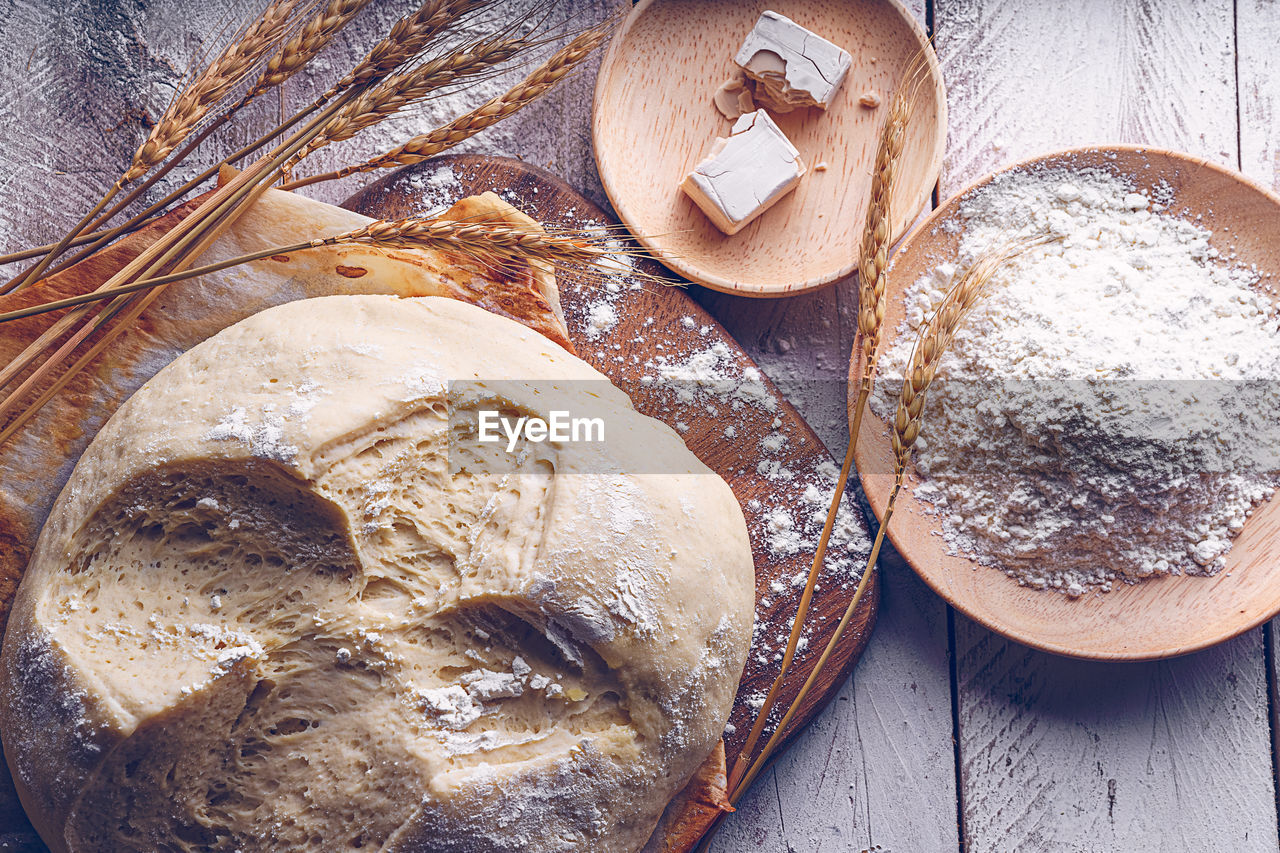Fermented bread with spikes of wheat, flour and yeast. traditional gastronomic concept