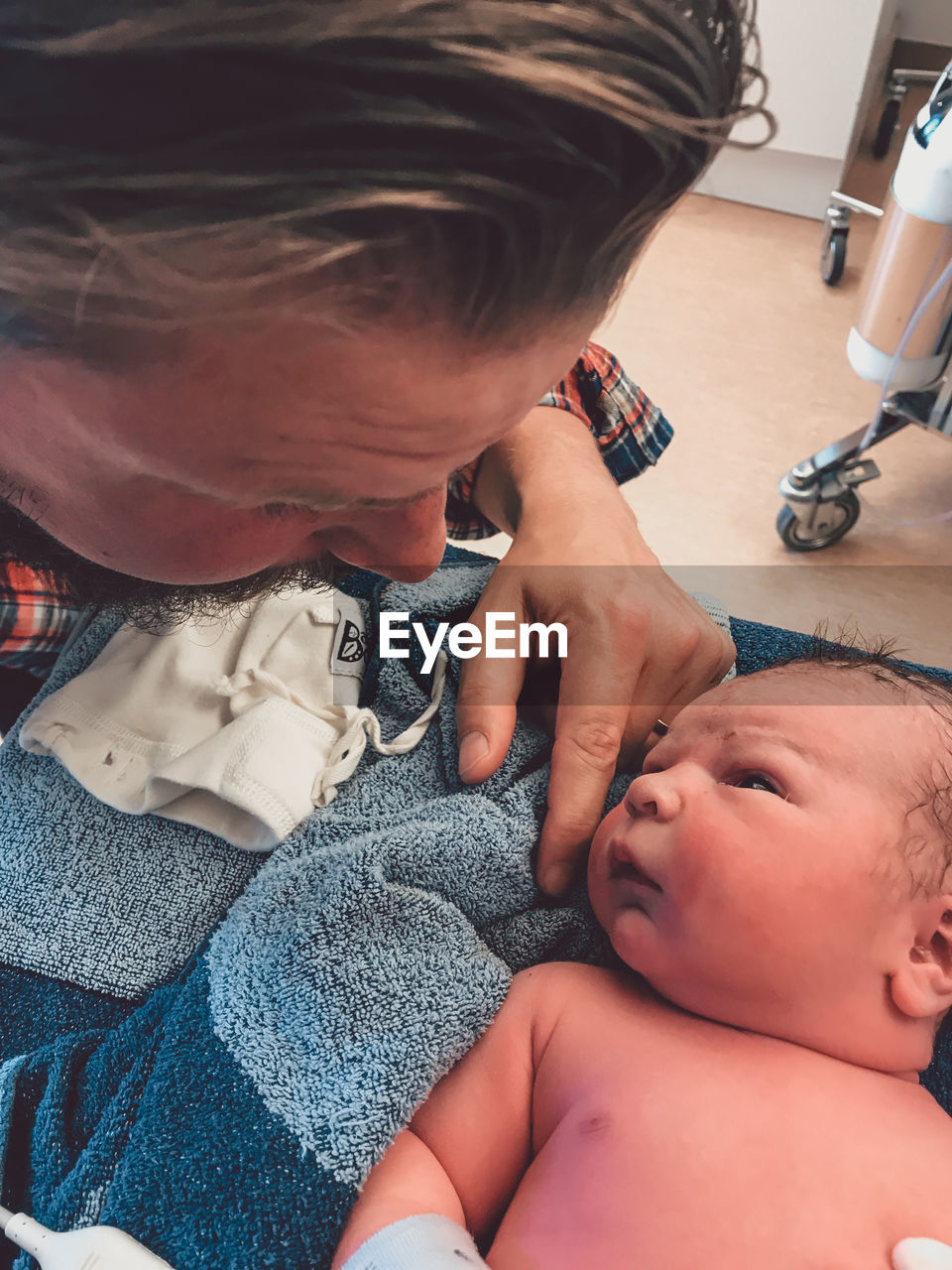 Close-up of father with shirtless son at home