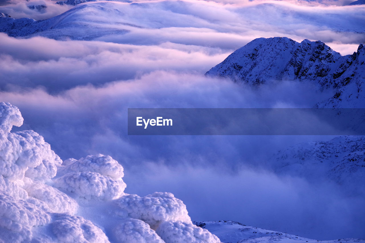 SCENIC VIEW OF SNOW COVERED MOUNTAINS AGAINST SKY DURING WINTER