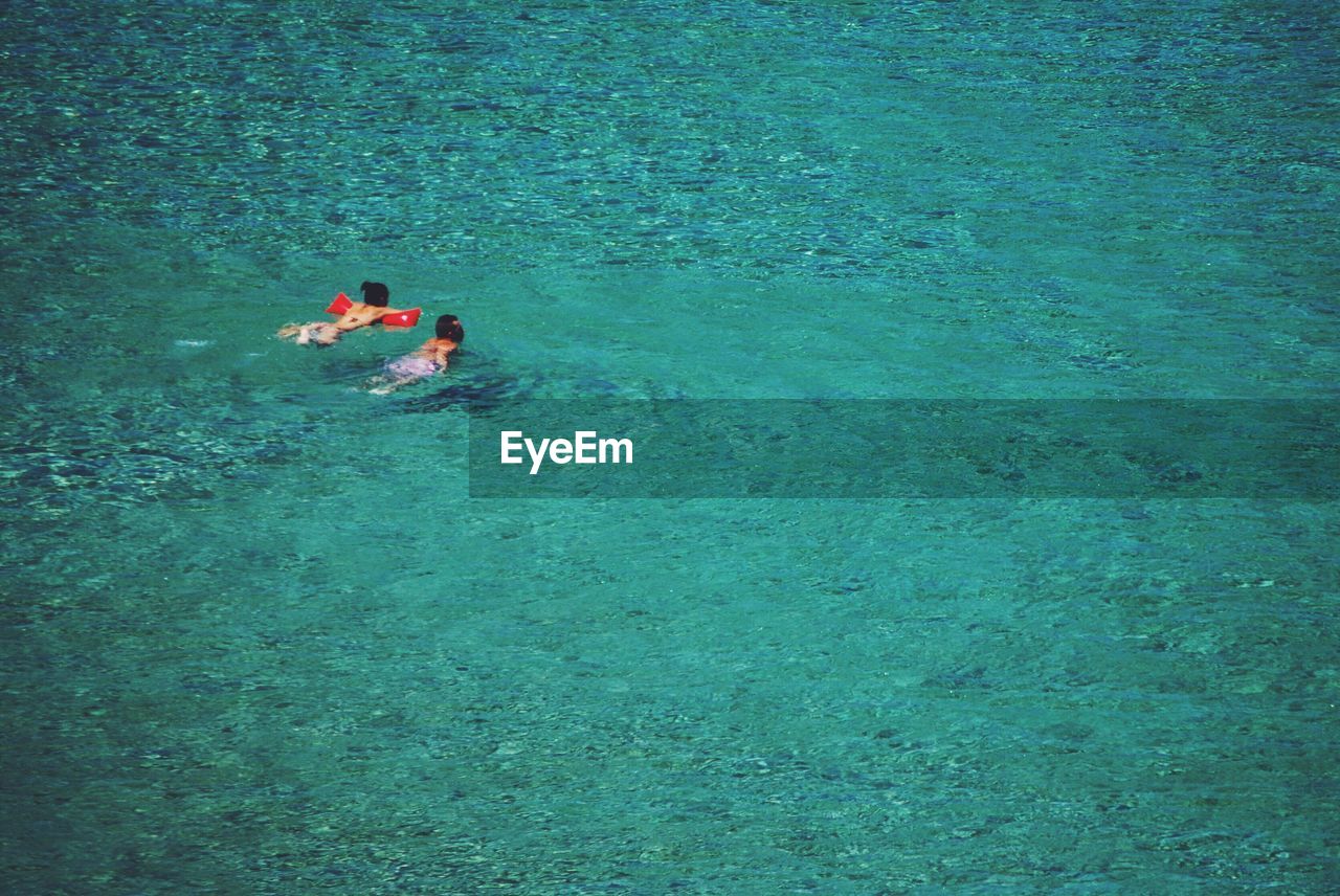 High angle view of men swimming in sea