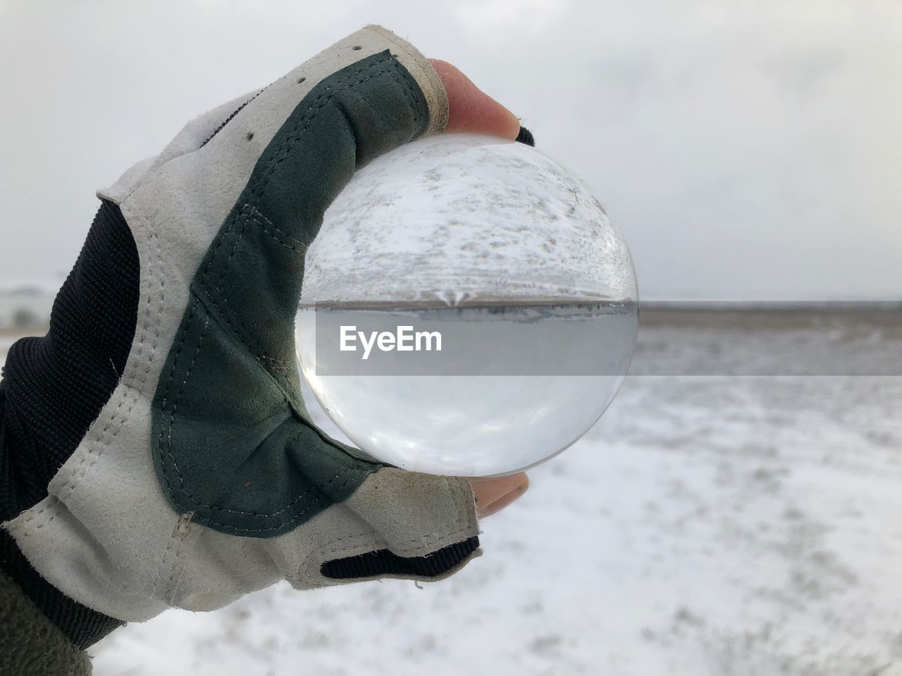 Close-up of crystal ball on snow covered land