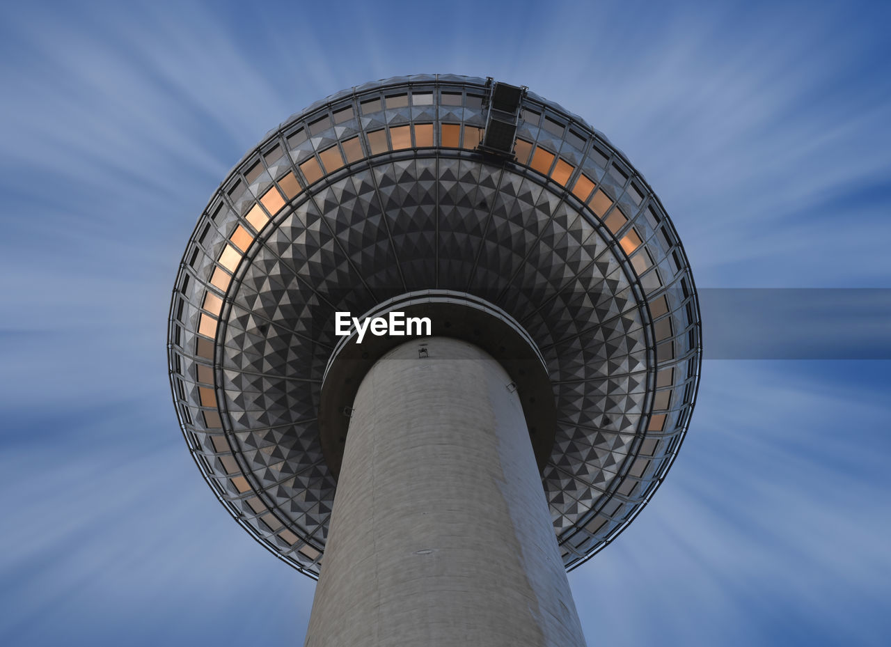 LOW ANGLE VIEW OF COMMUNICATIONS TOWER AGAINST SKY IN CITY