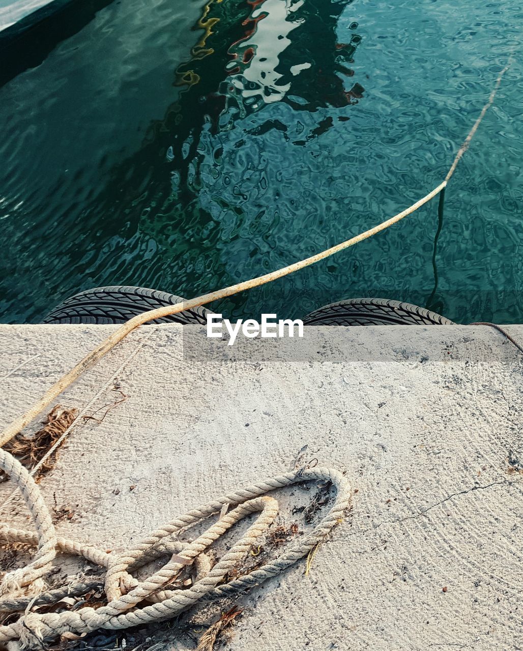 View of ropes on jetty by water