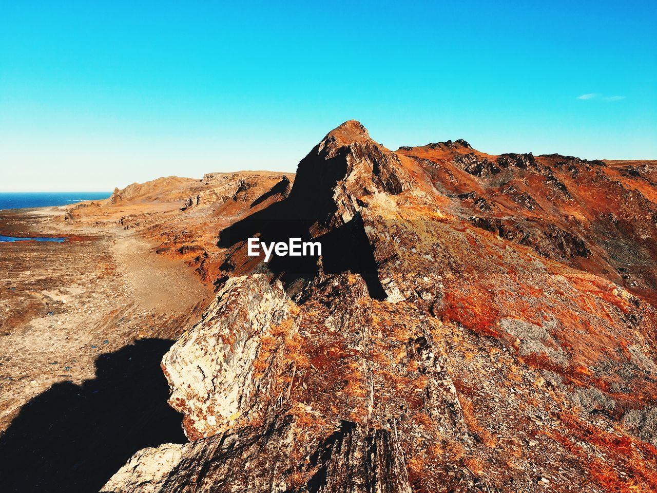 Rock formations against clear blue sky