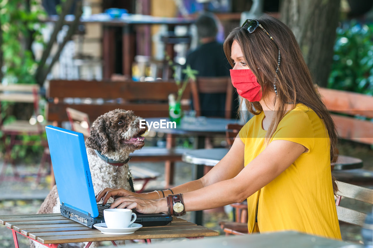 CLOSE-UP OF A DOG WITH COFFEE CUP