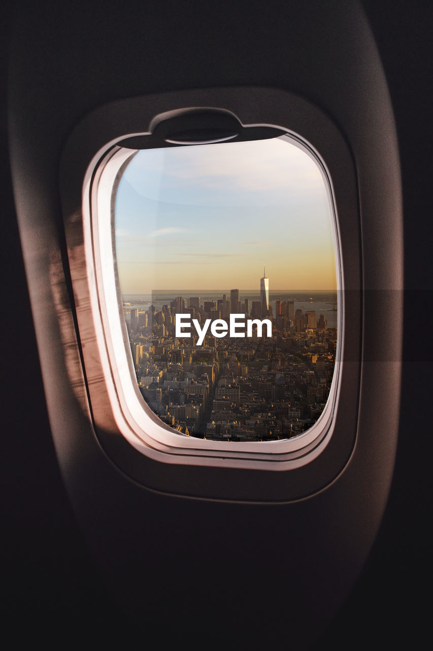 VIEW OF CITYSCAPE THROUGH WINDOW