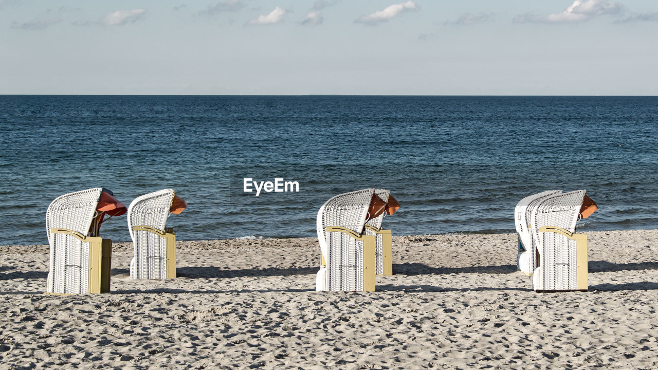 CHAIRS ON BEACH AGAINST SEA