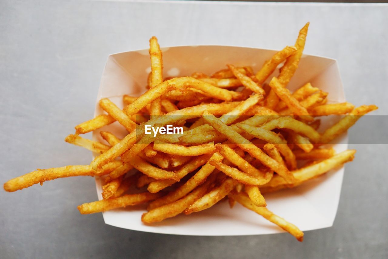 High angle view of french fries in box on table