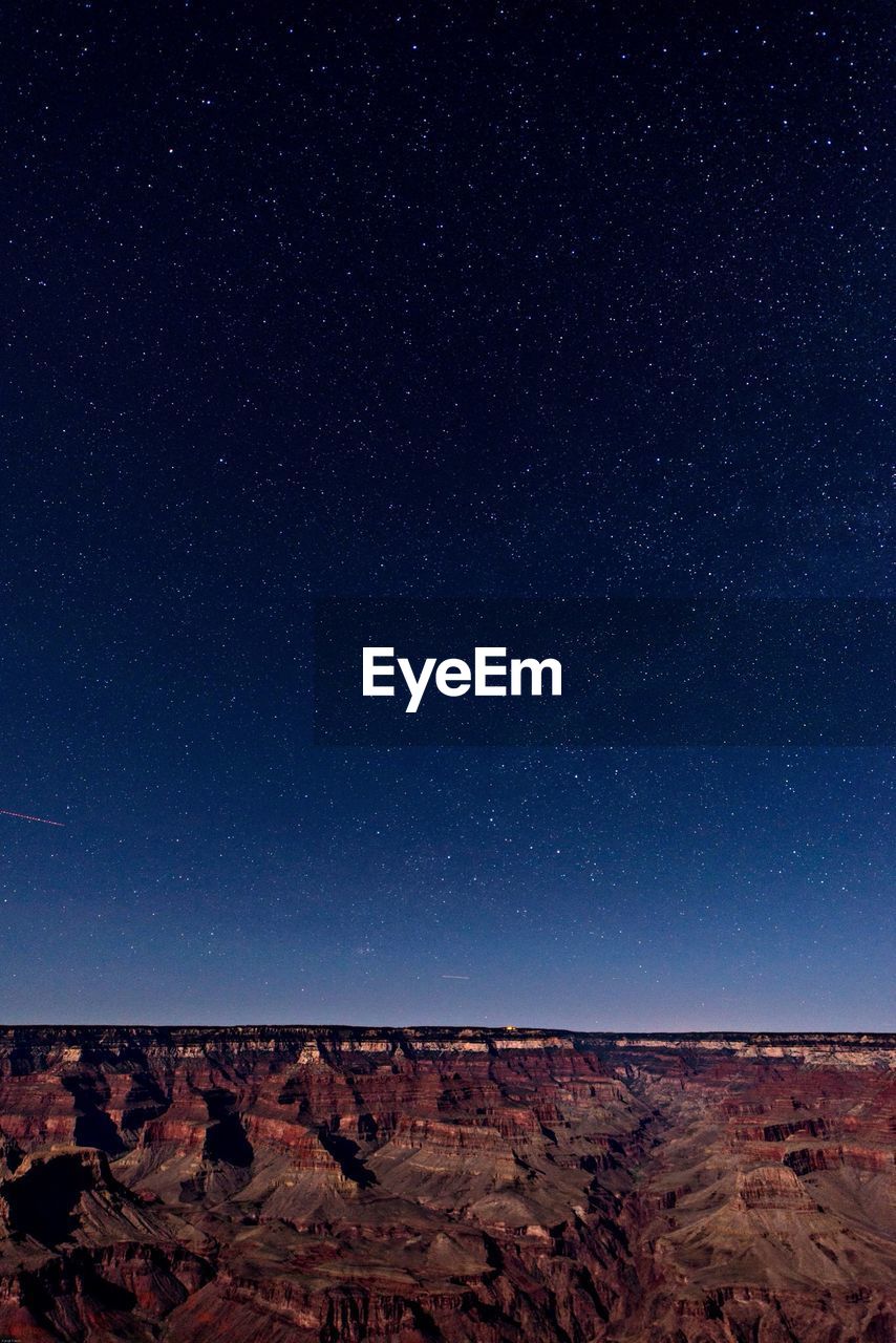 Scenic view of grand canyon against star field at night