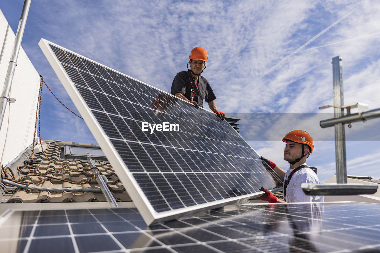 Engineers together installing solar panels