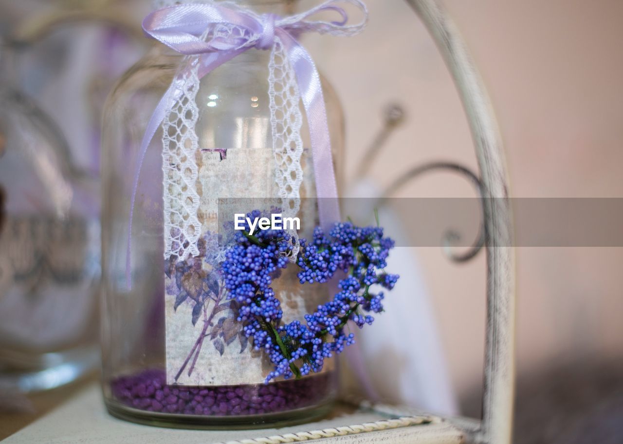 CLOSE-UP OF PURPLE FLOWERS ON TABLE