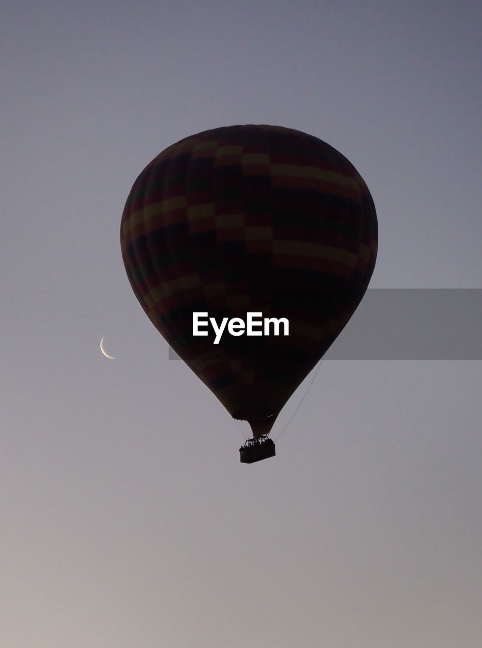 hot air balloon, balloon, air vehicle, mid-air, aircraft, flying, hot air ballooning, transportation, vehicle, adventure, sky, toy, mode of transportation, wing, nature, low angle view, travel, clear sky, no people, environment, outdoors, ballooning festival, helium, motion, journey