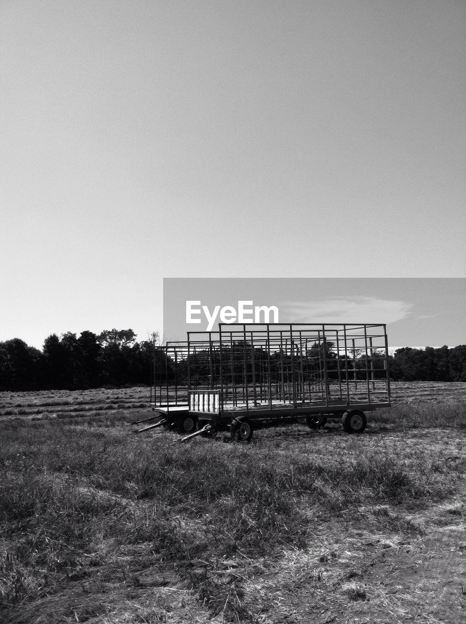 Side view of an empty cart at field against clear sky