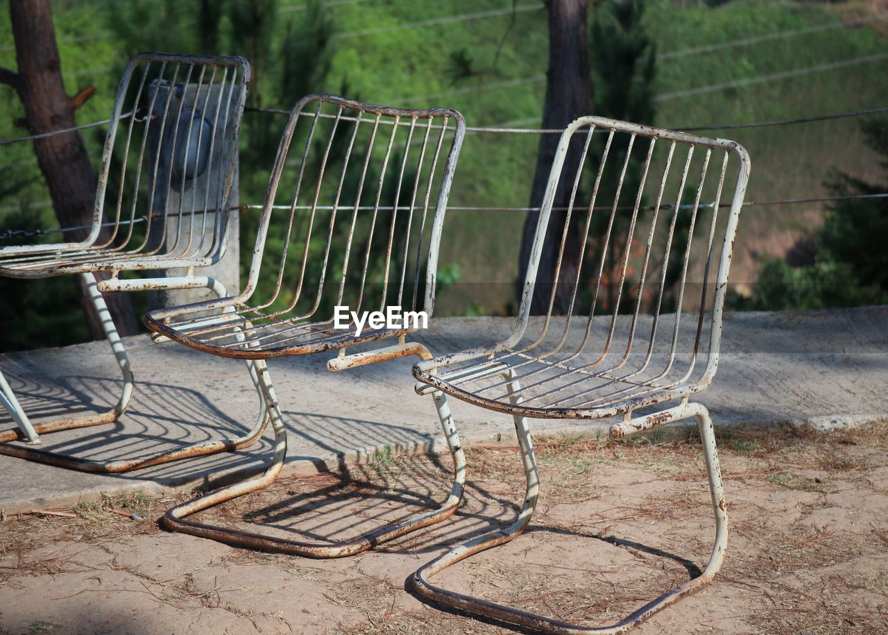 Empty chairs and tables in forest