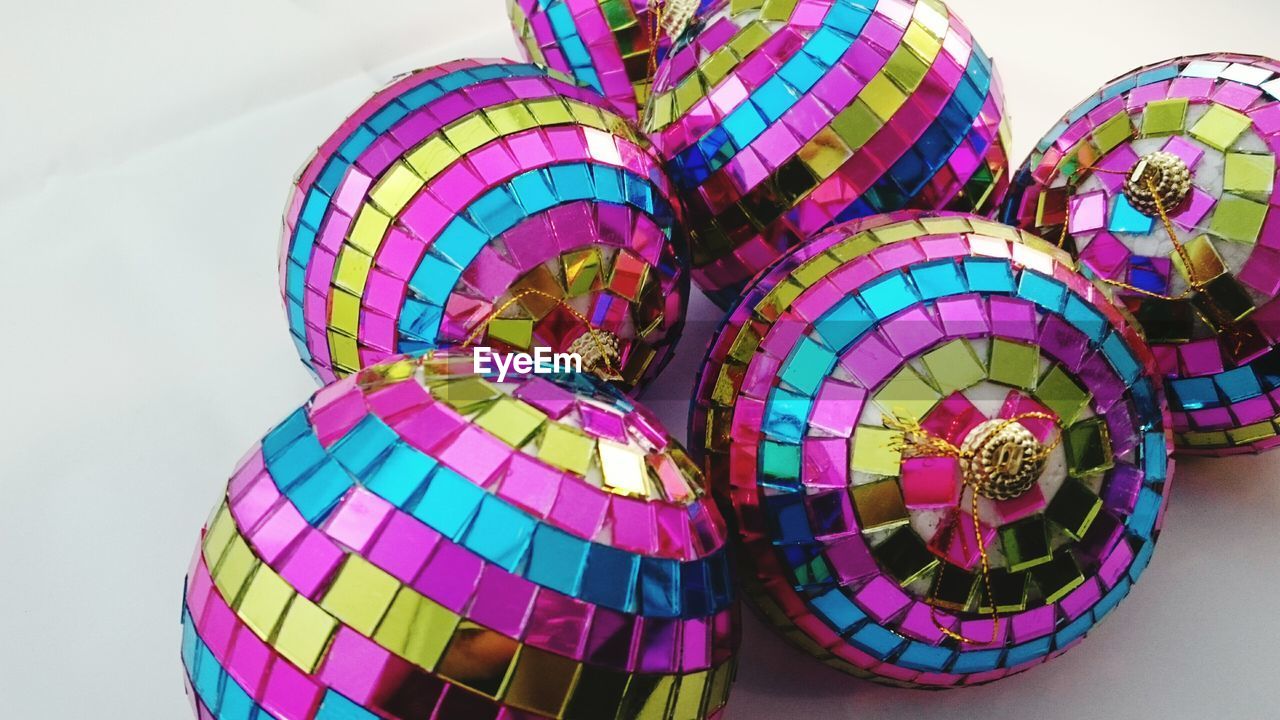 LOW ANGLE VIEW OF COLORFUL UMBRELLAS IN ILLUMINATED ROOM