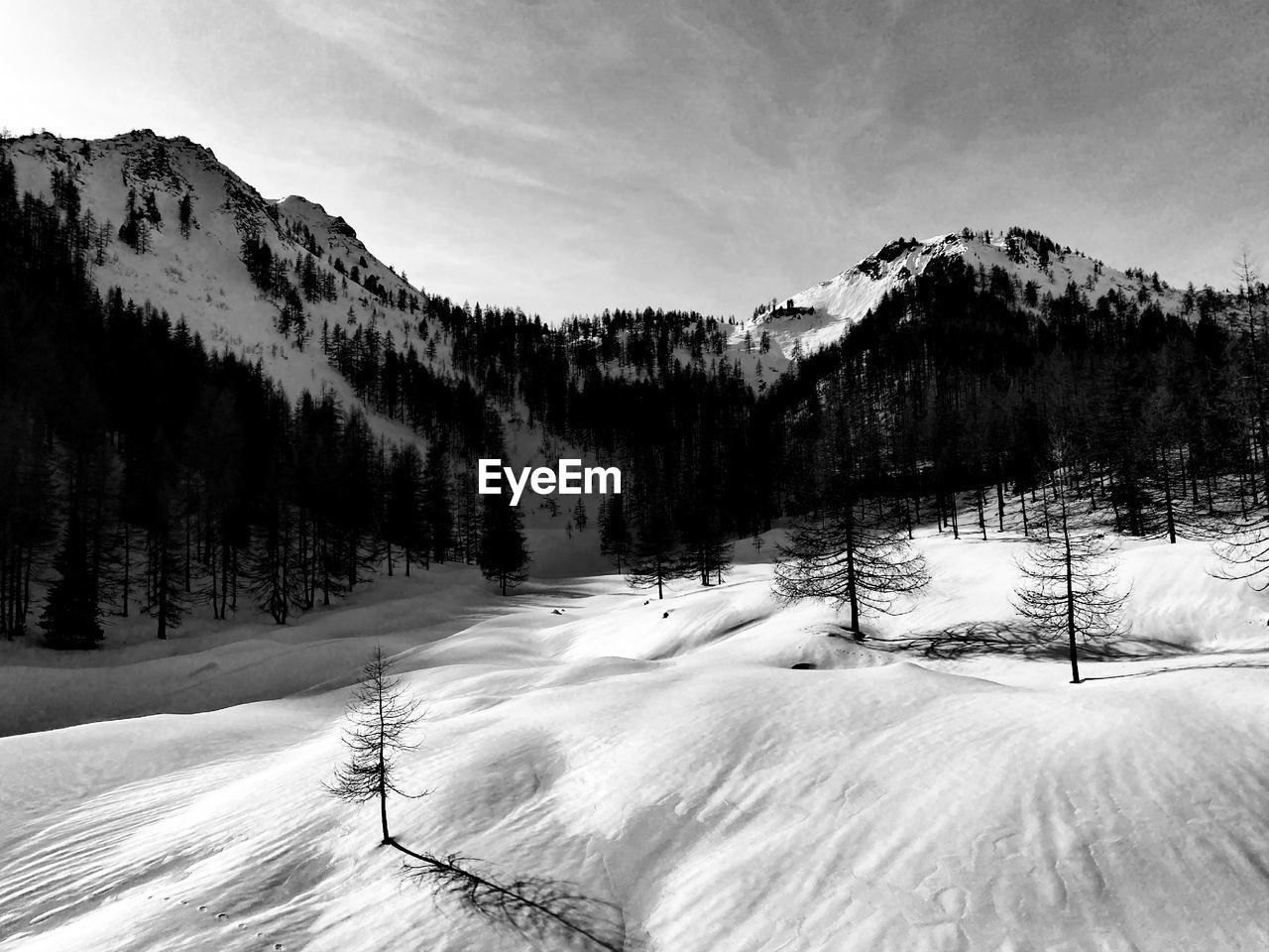 Scenic view of snow covered mountains against sky