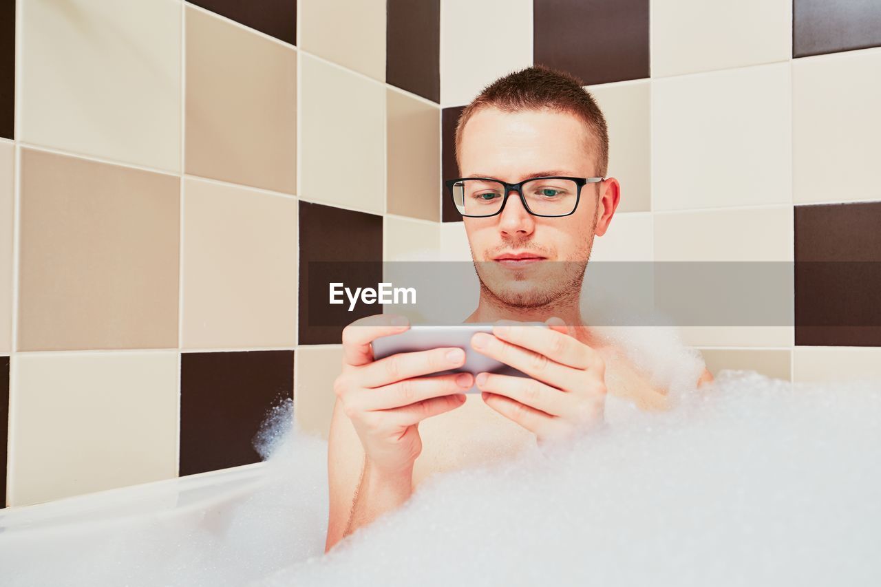 Portrait of young man in bathroom