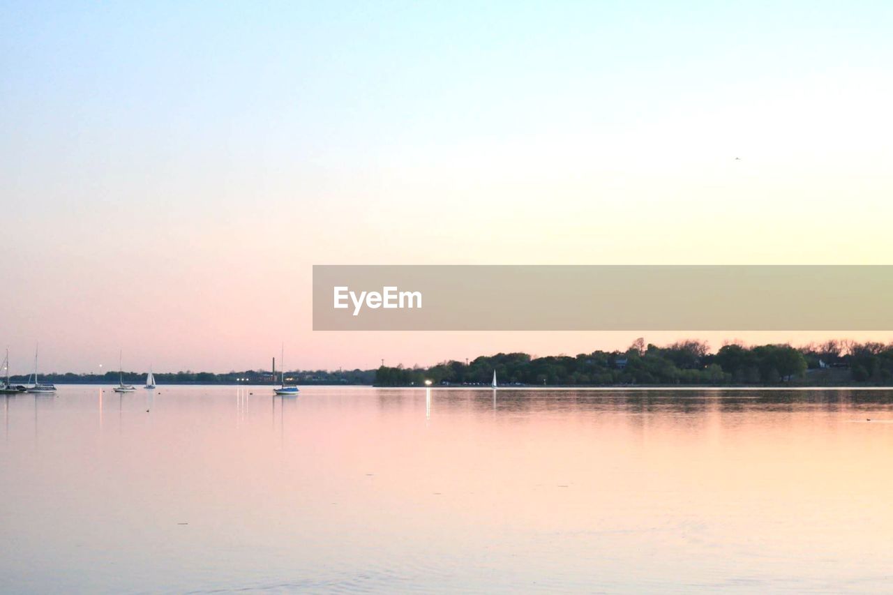 Scenic view of lake at sunset