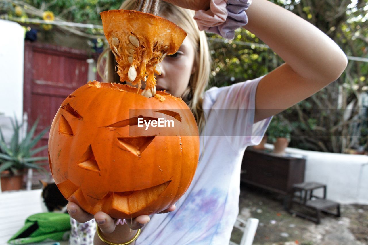 Midsection of woman with pumpkins