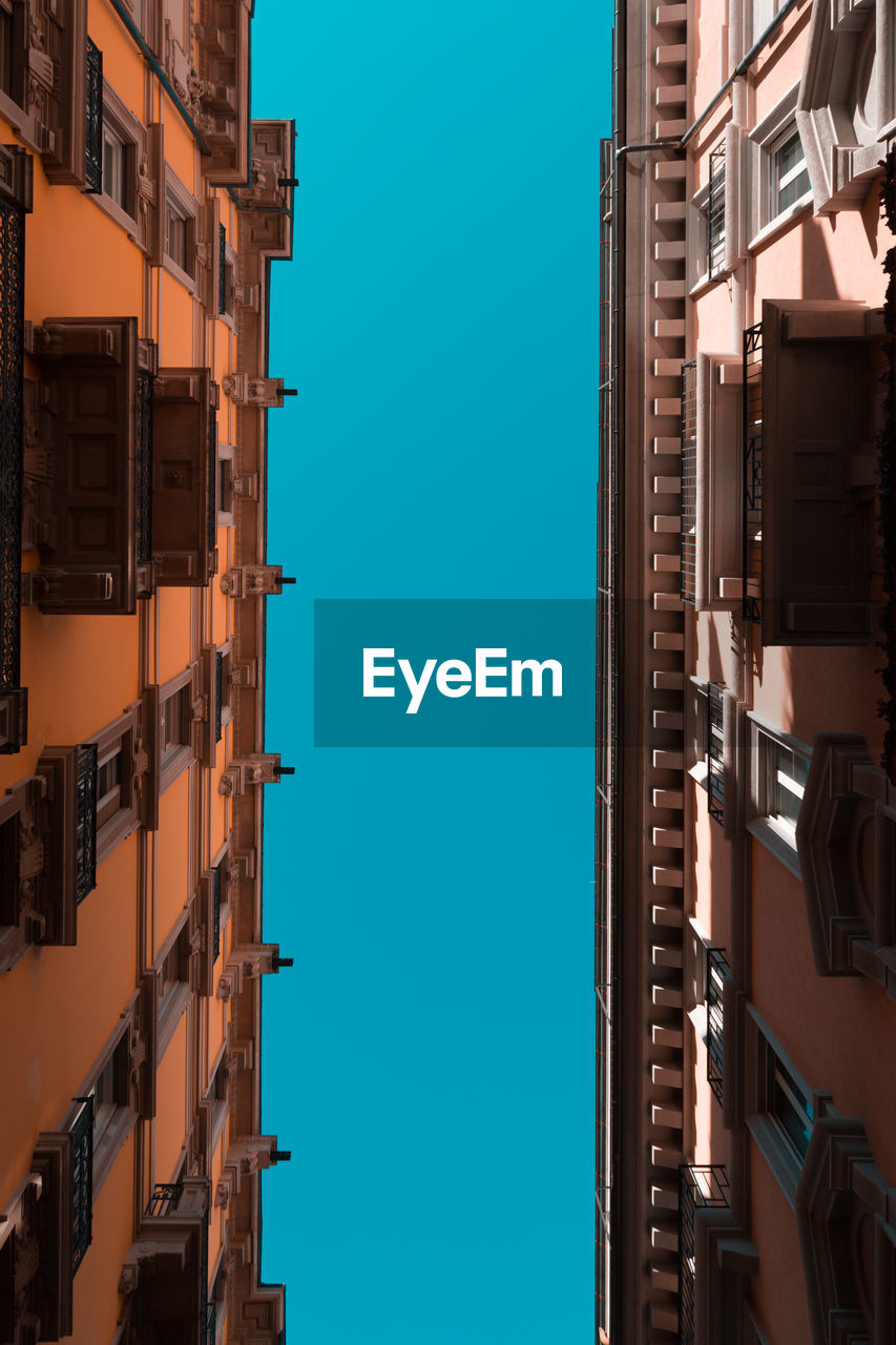 Low angle view of buildings against blue sky