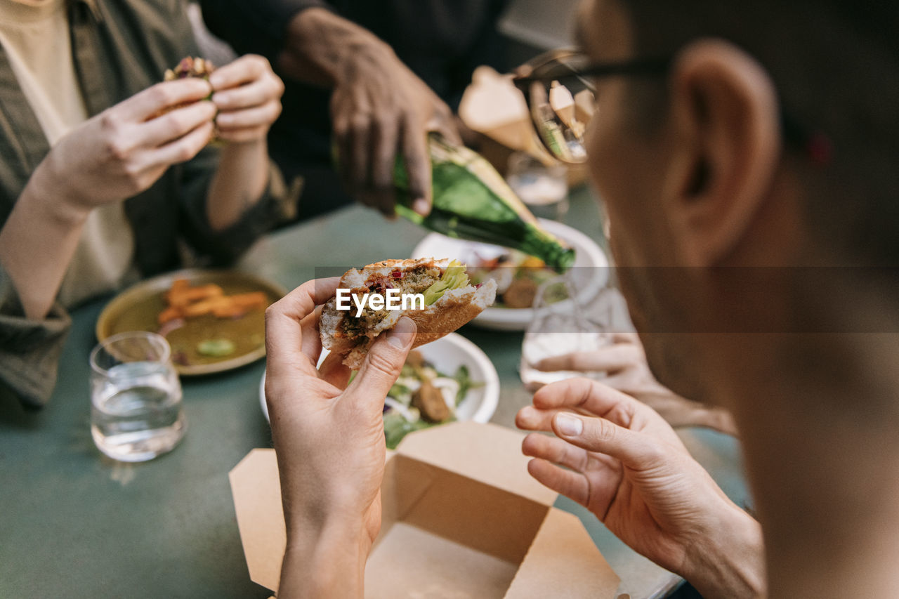 Man eating burger at restaurant