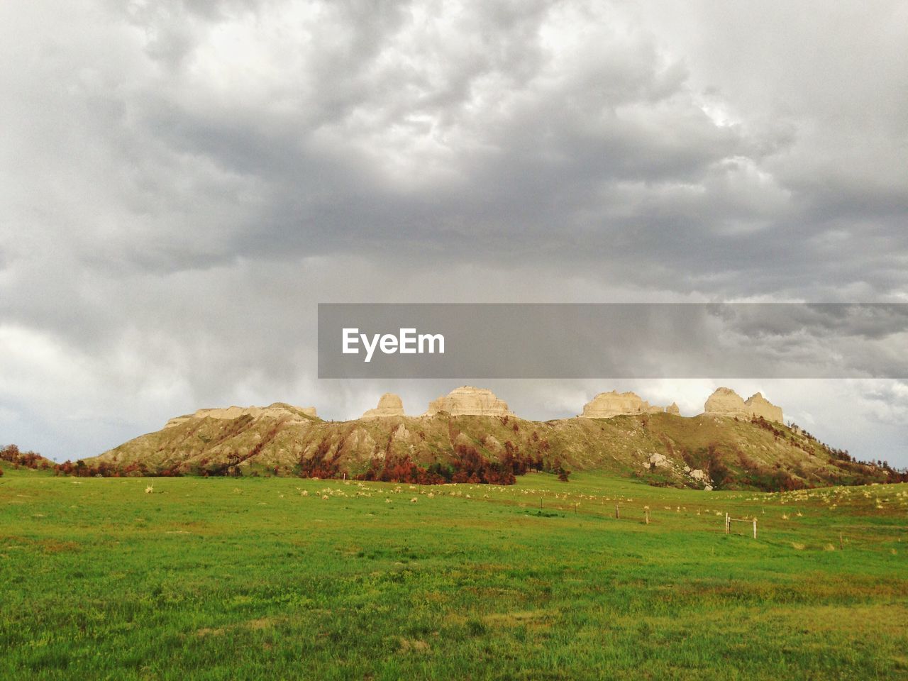 Scenic view of field and mountains against sky