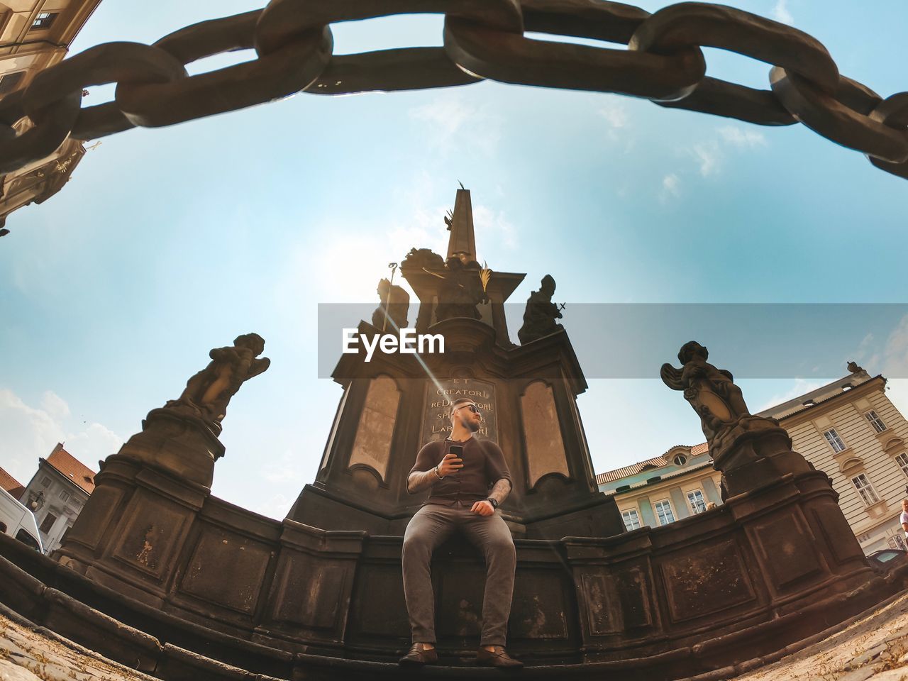 LOW ANGLE VIEW OF STATUE AGAINST BUILDINGS