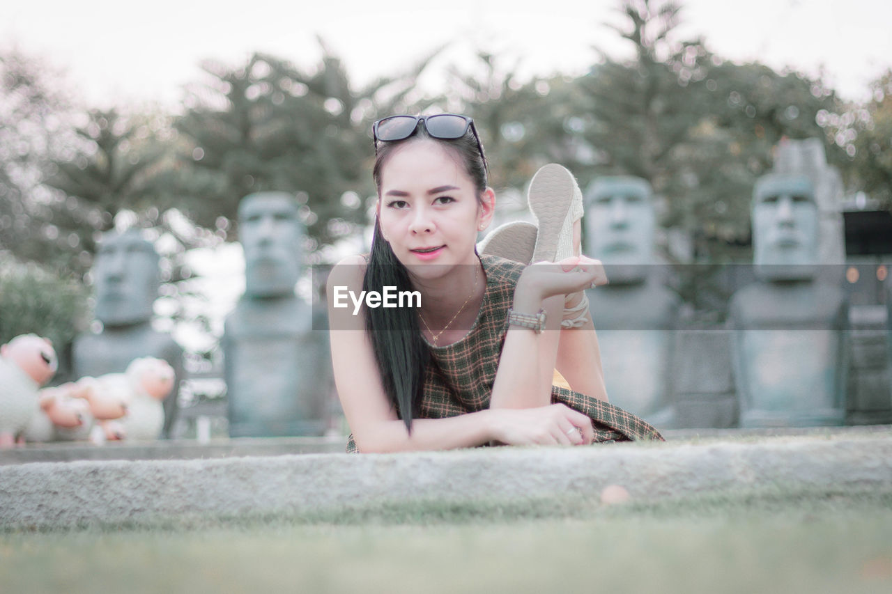 Portrait of smiling woman relaxing in park