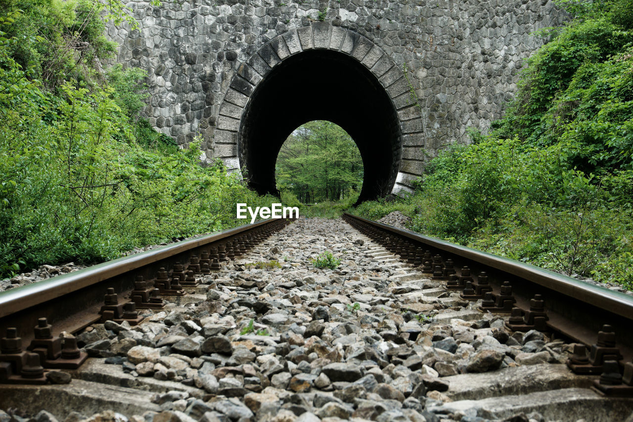 Railroad tracks leading to tunnel