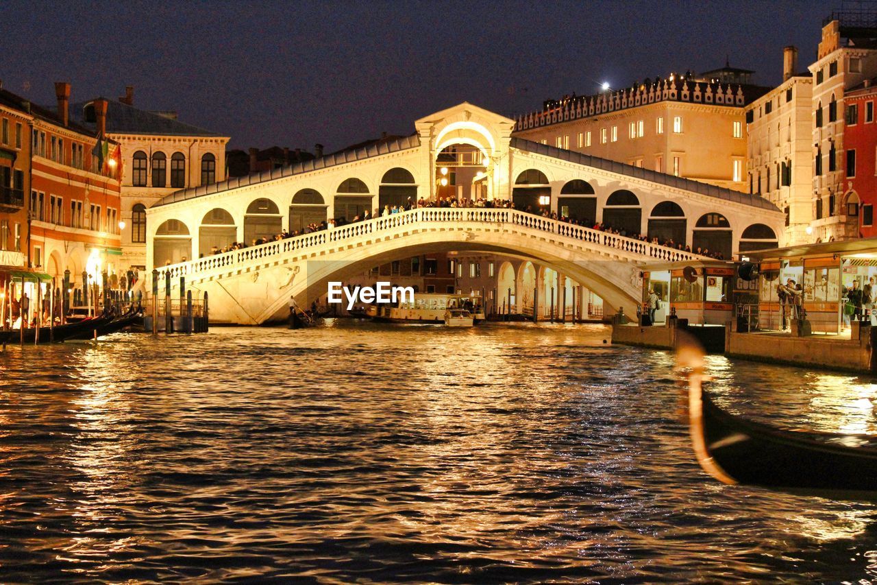 View of canal in city at night