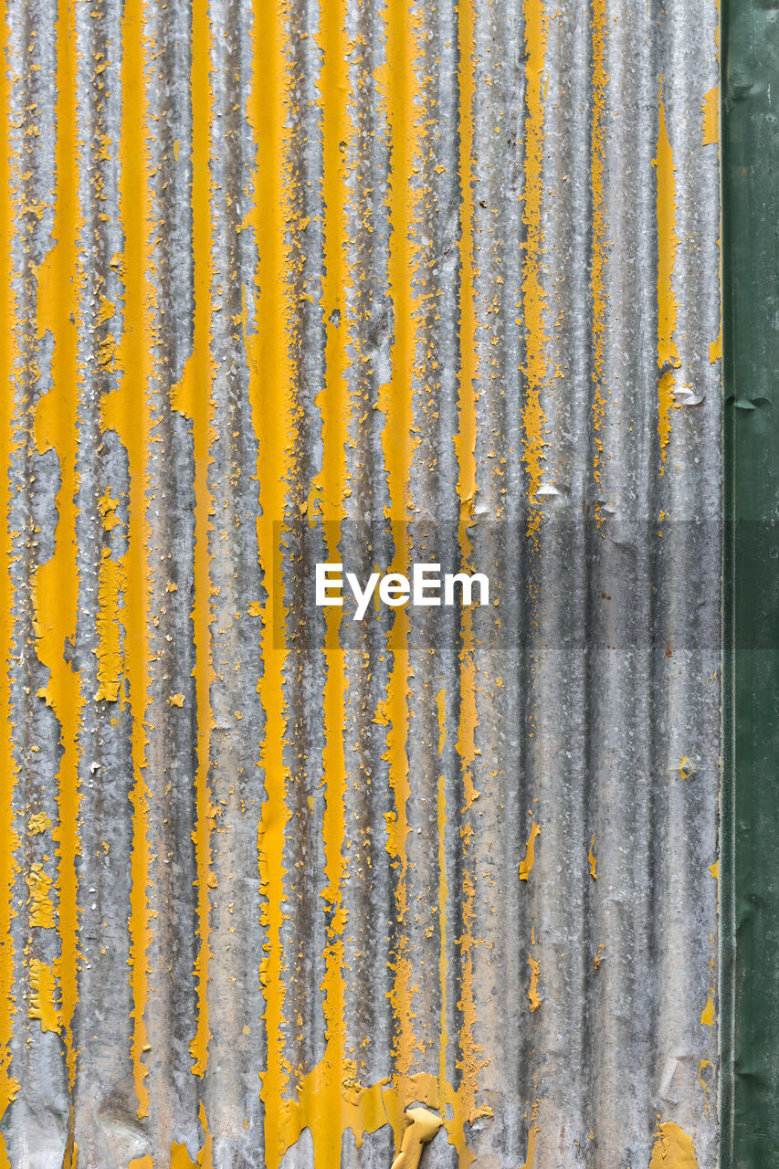 Old yellow corrugated iron background and texture