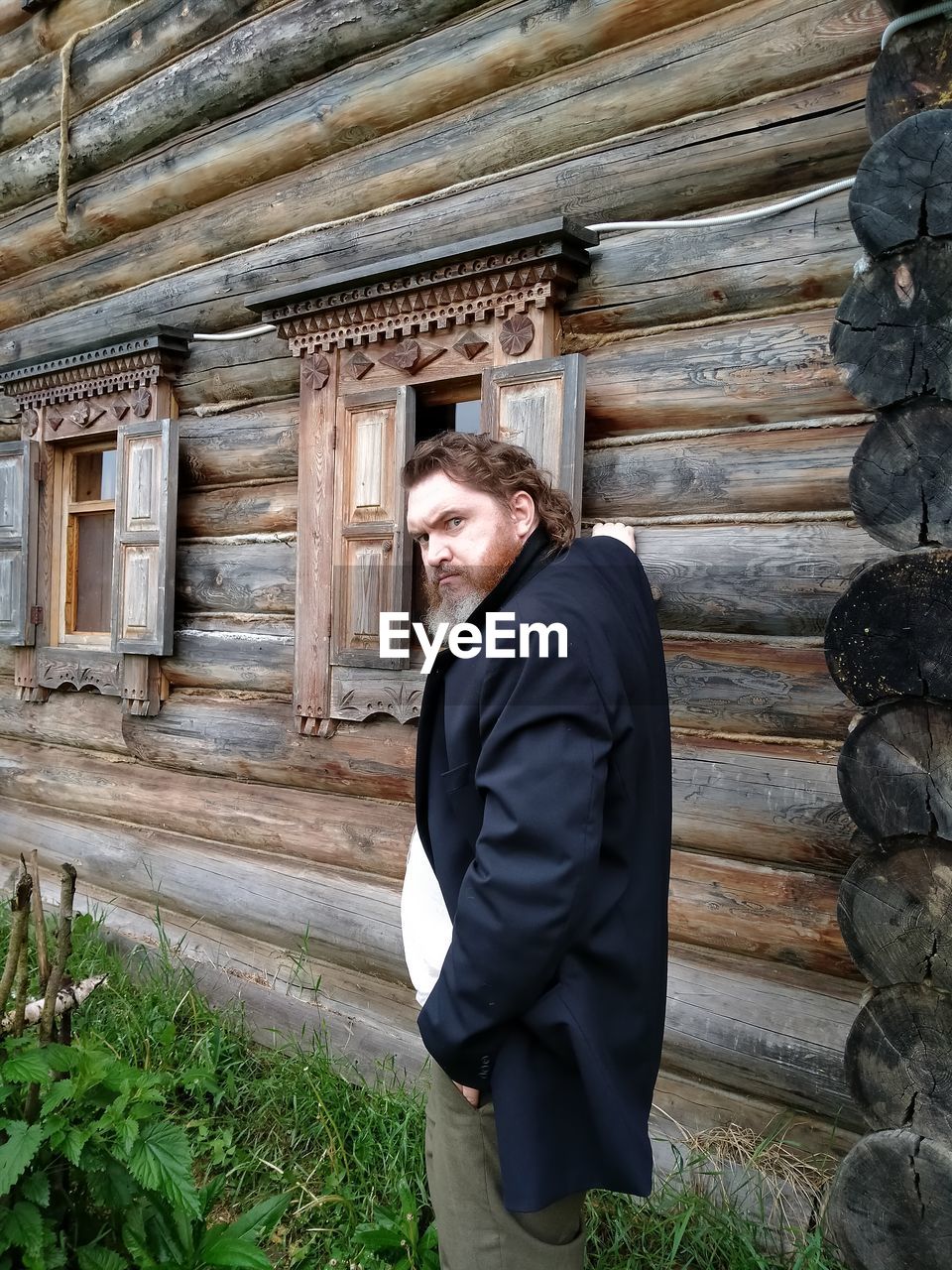 Man standing outside house