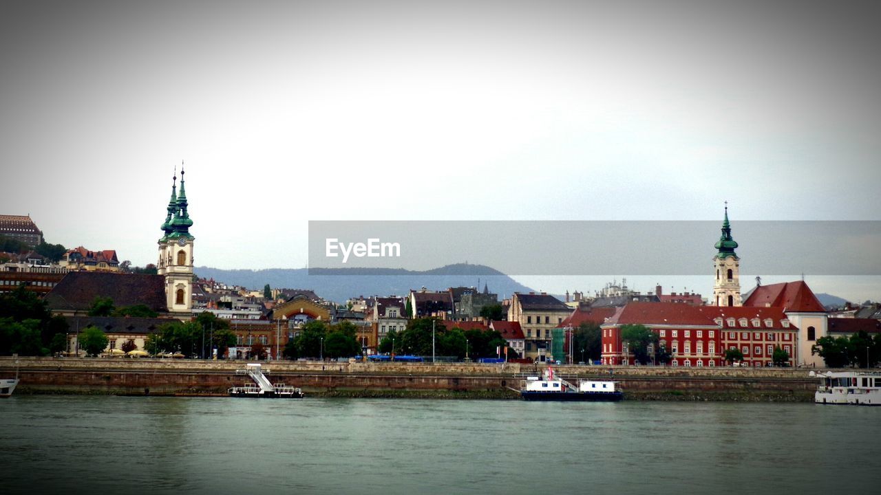 VIEW OF RIVER WITH BUILDINGS IN BACKGROUND