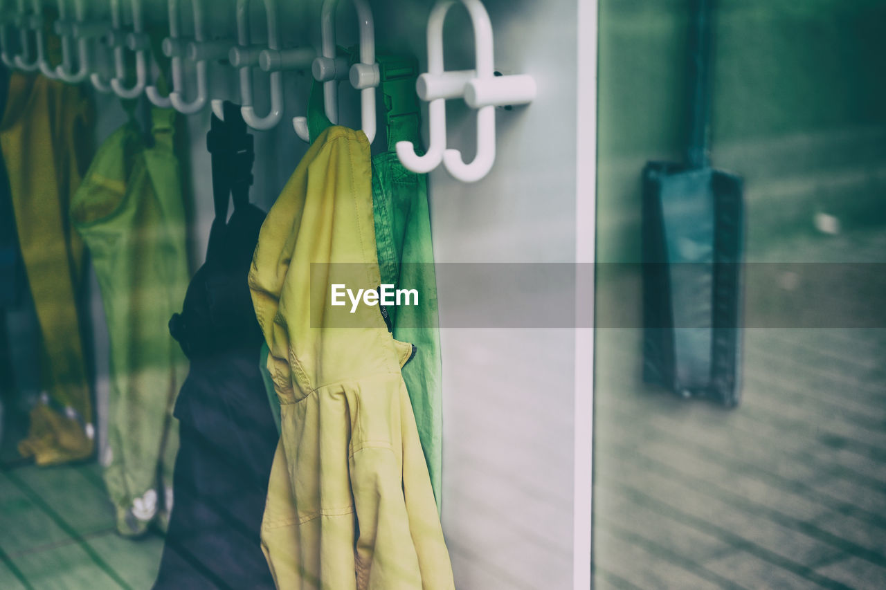 green, clothing, yellow, hanging, coathanger, blue, dress, fashion, indoors, store, no people, spring, focus on foreground, retail, shopping