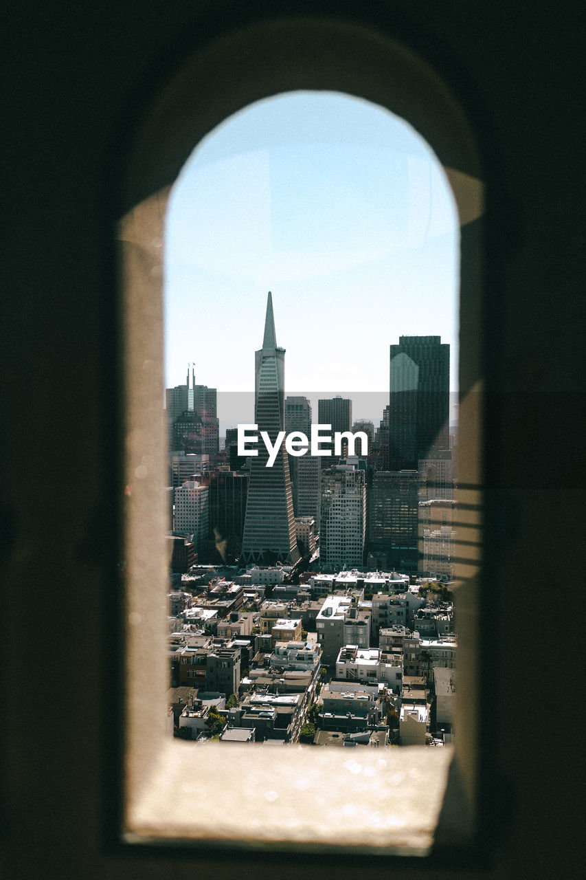 Cityscape against sky seen through window