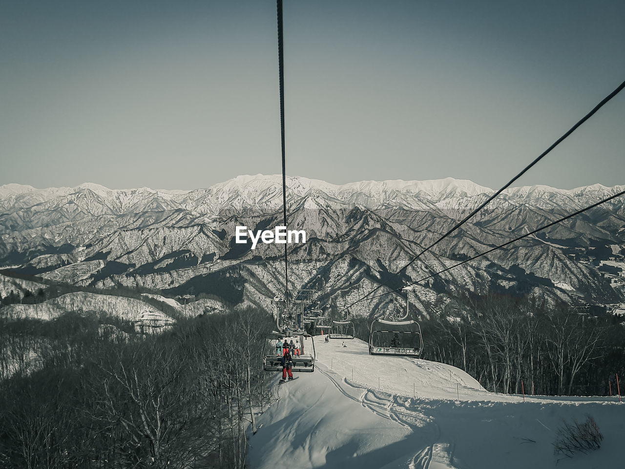 SKI LIFT ON SNOWCAPPED MOUNTAINS