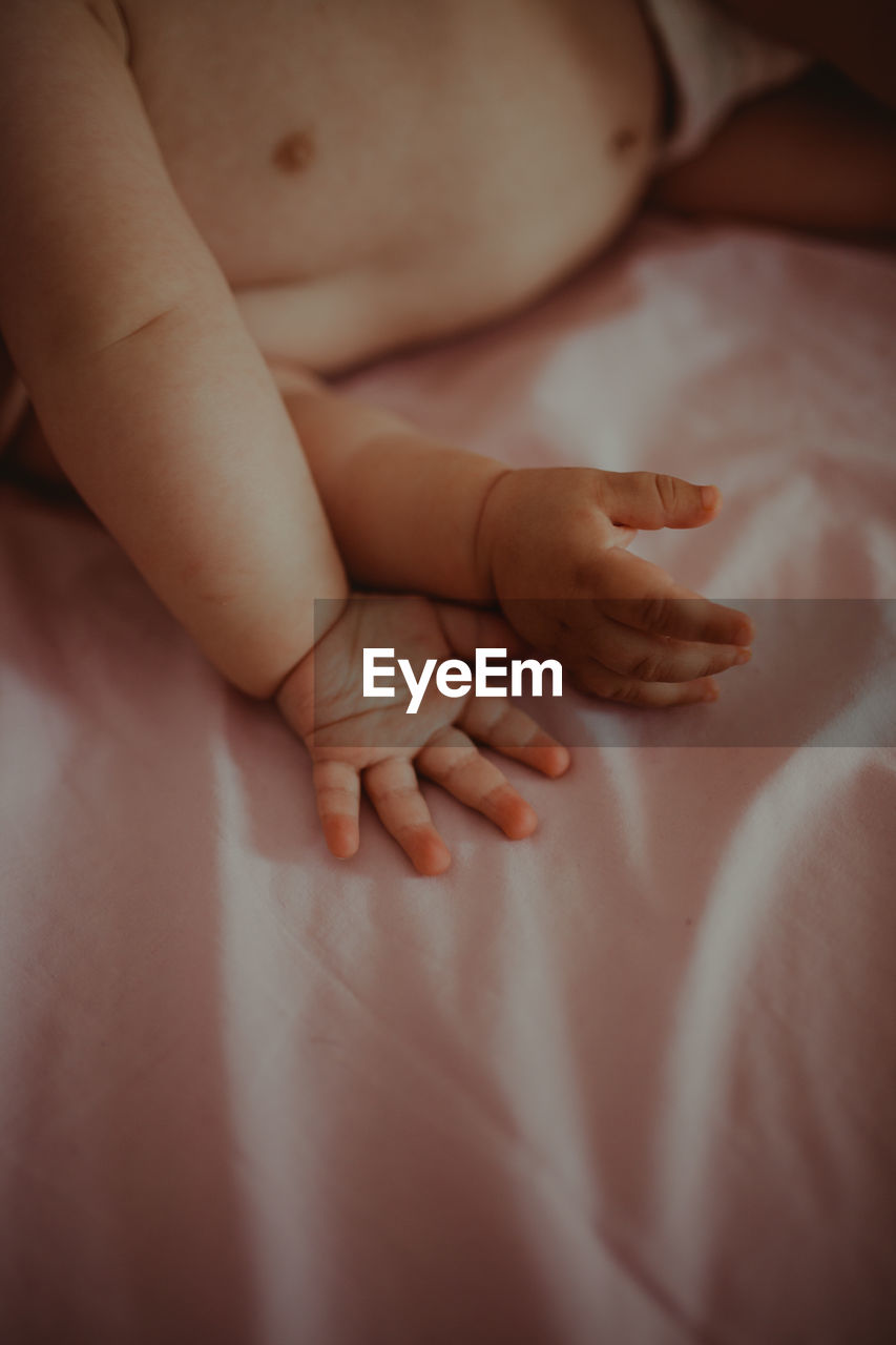 High angle view of baby boy lying on bed