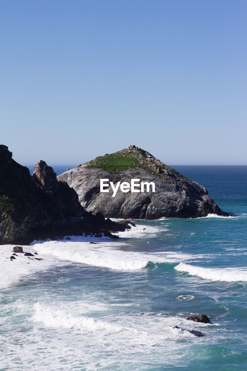 Scenic view of sea against clear blue sky