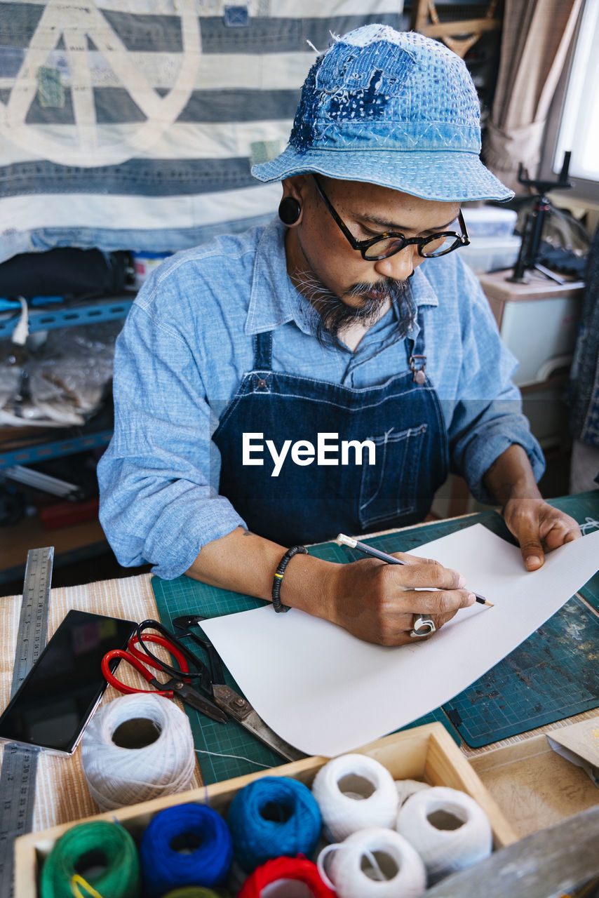 Man working over paper on table