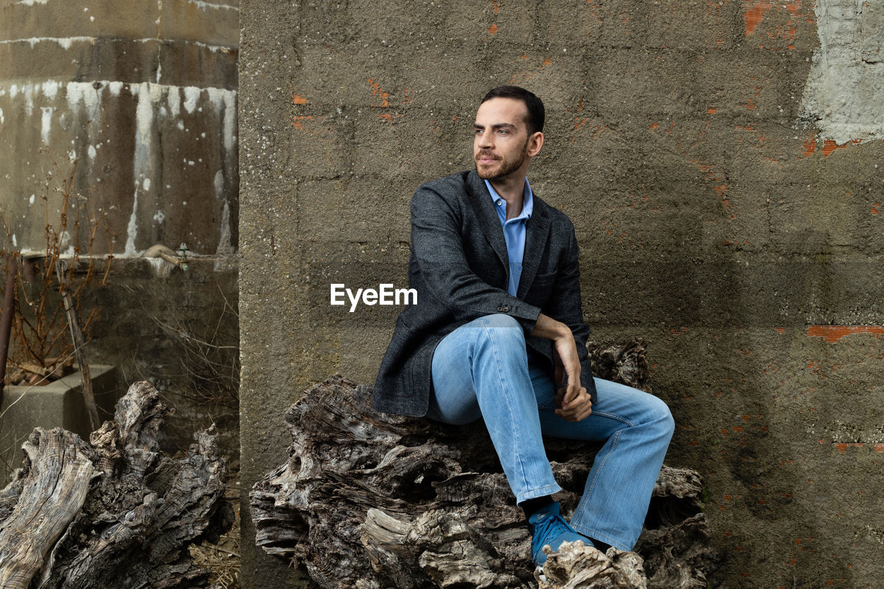 Portrait of young man sitting outdoors