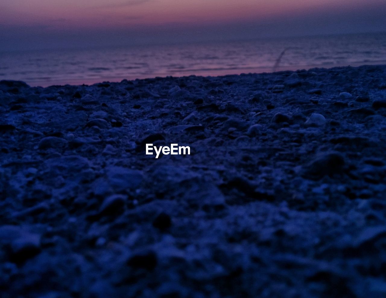 SCENIC VIEW OF BEACH DURING SUNSET