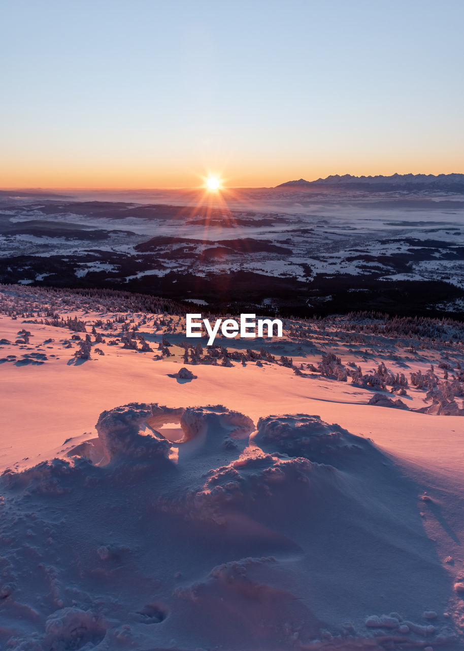 Scenic view of land against sky during sunset