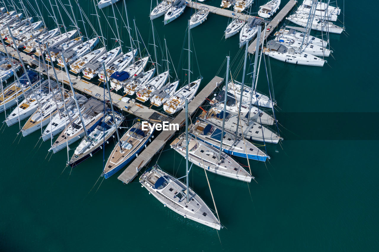 High angle view of sailboats moored at harbor