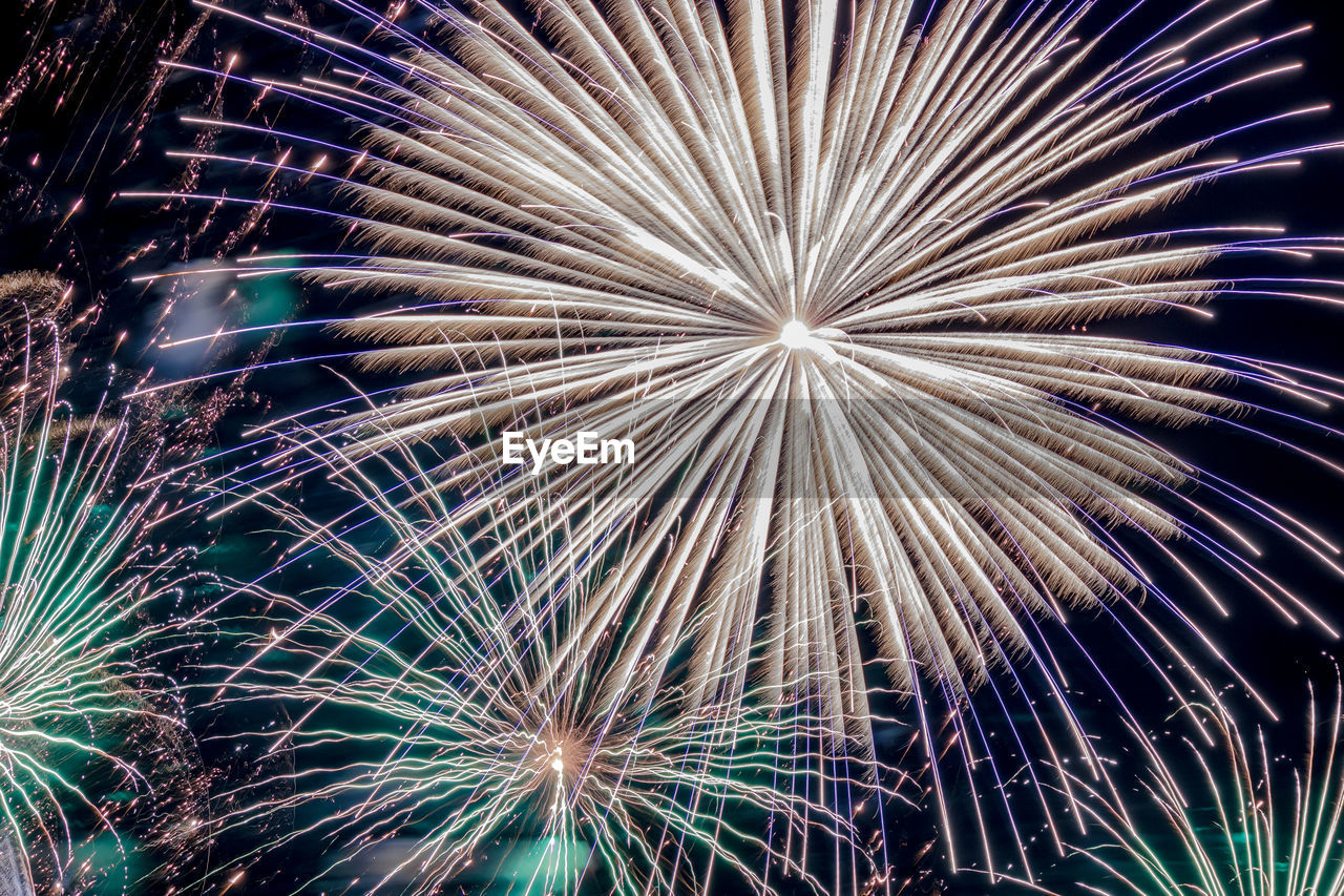 Low angle view of firework display at night